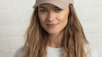 Pet-friendly Retro Canine Boston Terrier Cap. Perfect For Dog Lovers. Smiling Woman Wears The Cap With Casual Clothing.